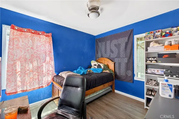 a bed sitting in a bedroom next to a window