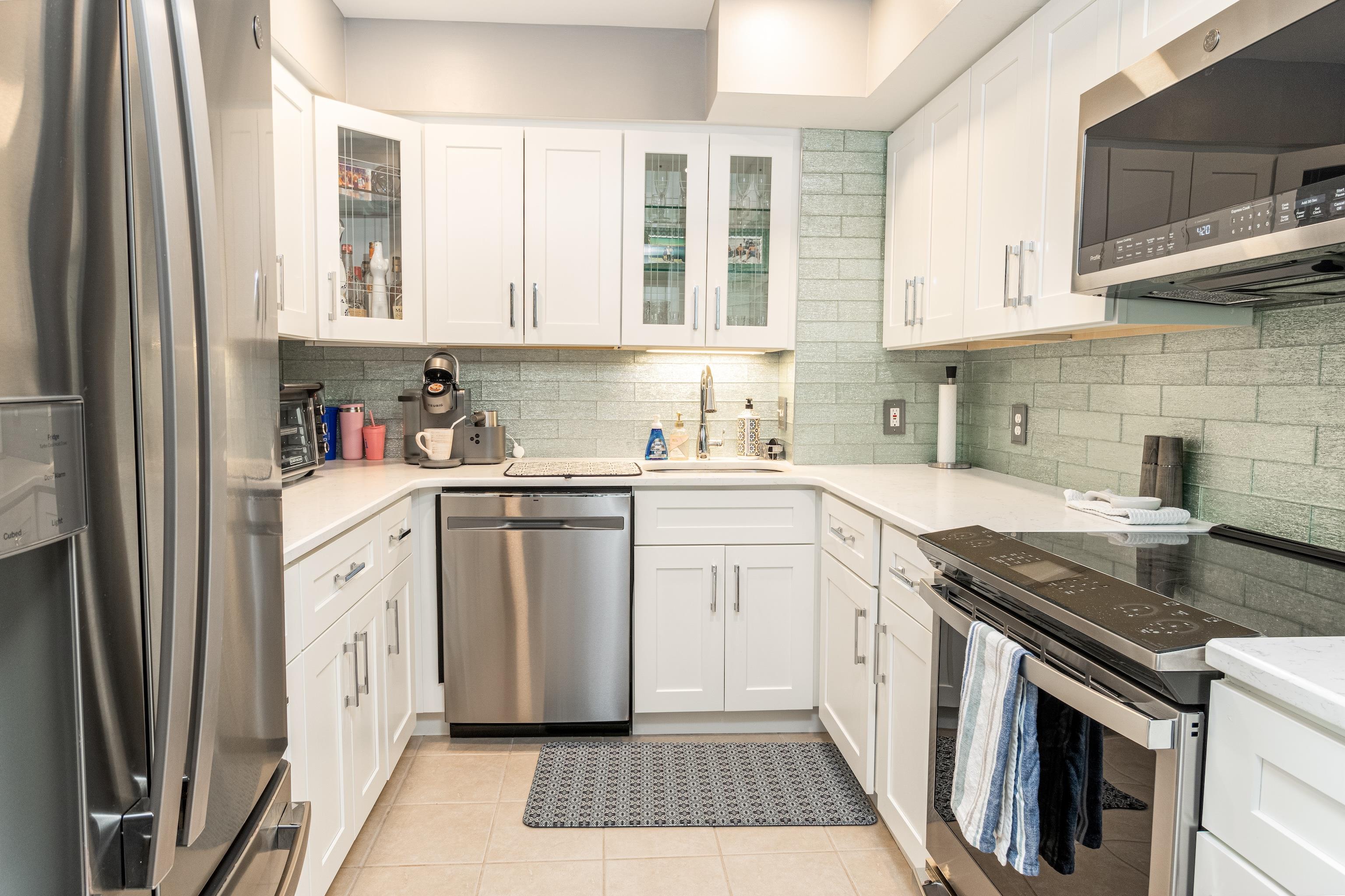 1708 Ocean Drive, Unit 6 Avalon, NJ 08202 - Photo 7 of 18 a kitchen with cabinets stainless steel appliances a sink and a stove