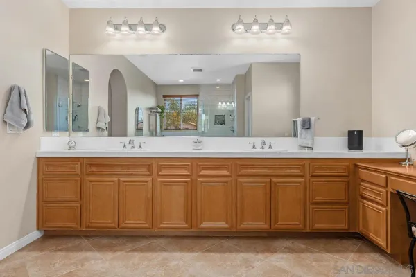 a spacious bathroom with a granite countertop sink a mirror and a
