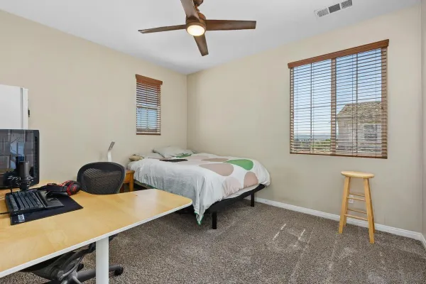 a bedroom with a bed and a window