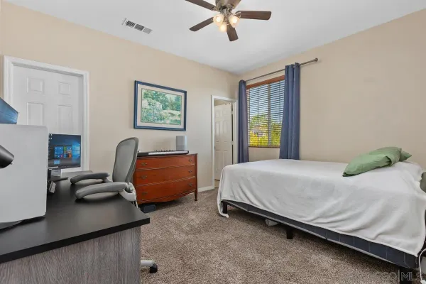 a bedroom with a bed and a couch