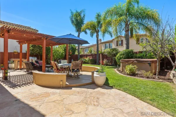 a view of a backyard with sitting area and furniture