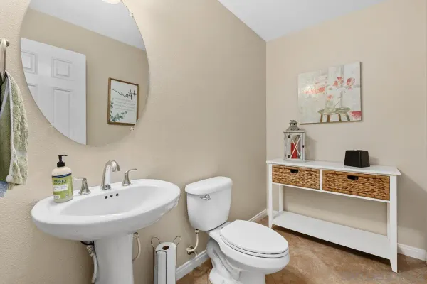 a bathroom with a sink mirror and toilet