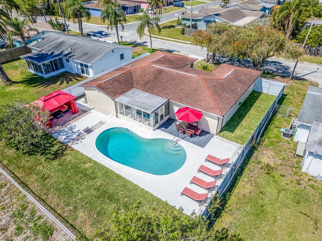 an aerial view of a house with a swimming pool