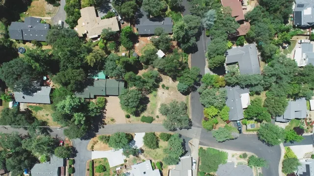 an aerial view of a house with a yard