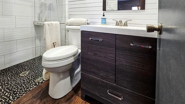 a bathroom with a sink toilet and shower