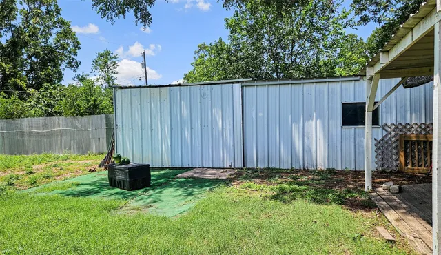 a view of a backyard with wooden fence
