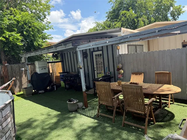 a patio with table and chairs