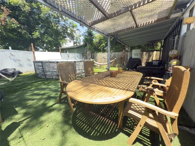 a view of a chairs and table in the patio