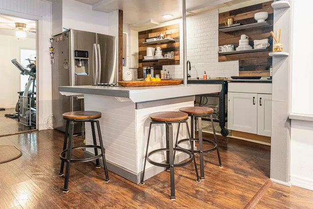 a table and chairs in a kitchen next to a window