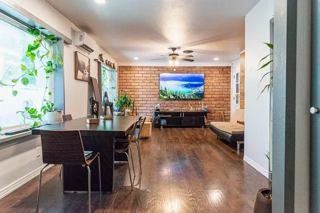 a view of a dining room with furniture a chandelier and wooden floor