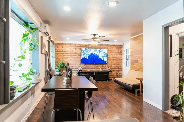 a view of a dining room with furniture a chandelier and wooden floor