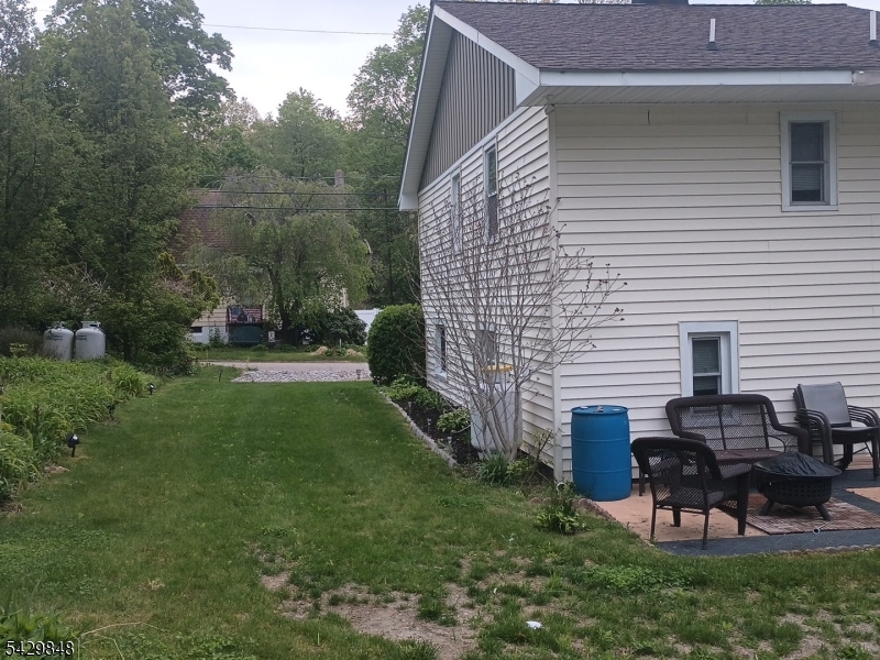 13 Ardena Road West Milford, NJ 07421 - Photo 3 of 14 a backyard of a house with table and chairs