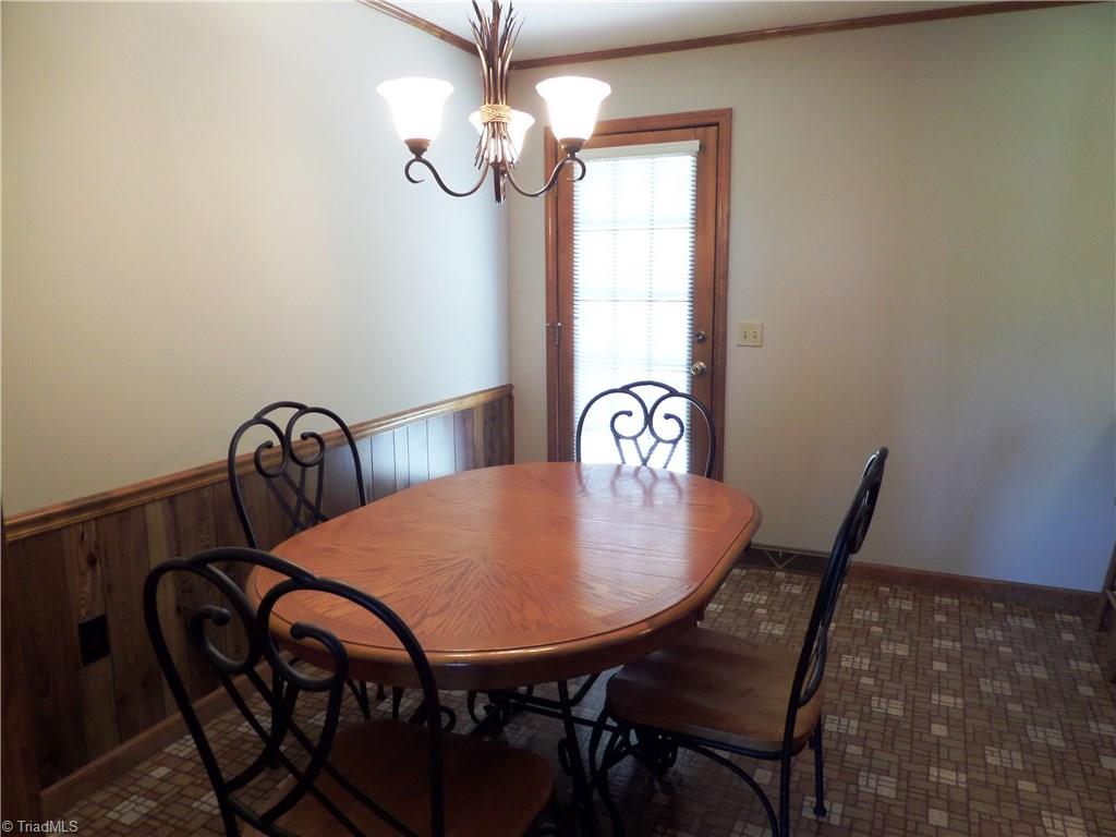 3308 Doub Road East Bend, NC 27018 - Photo 14 of 27 Breakfast area has a pretty chandelier and door to the deck.
