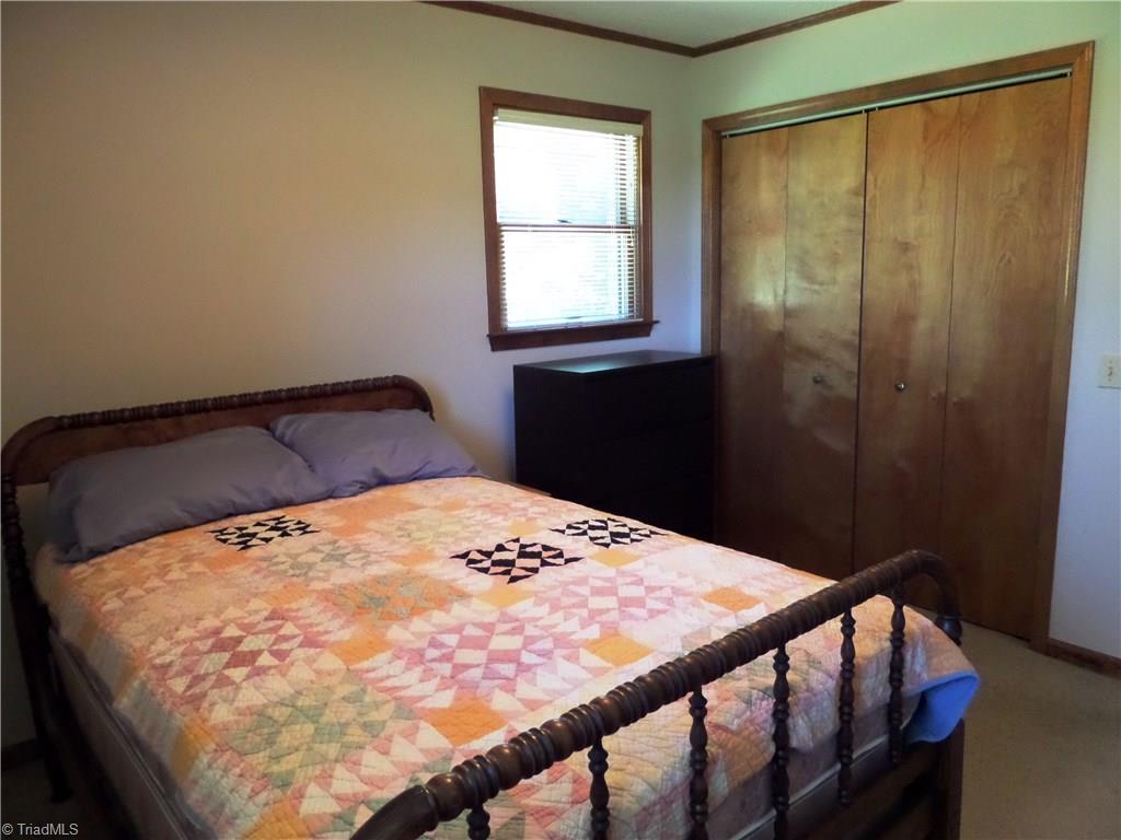 3308 Doub Road East Bend, NC 27018 - Photo 17 of 27 Second bedroom has crown molding, overhead light fixture and a double closet.