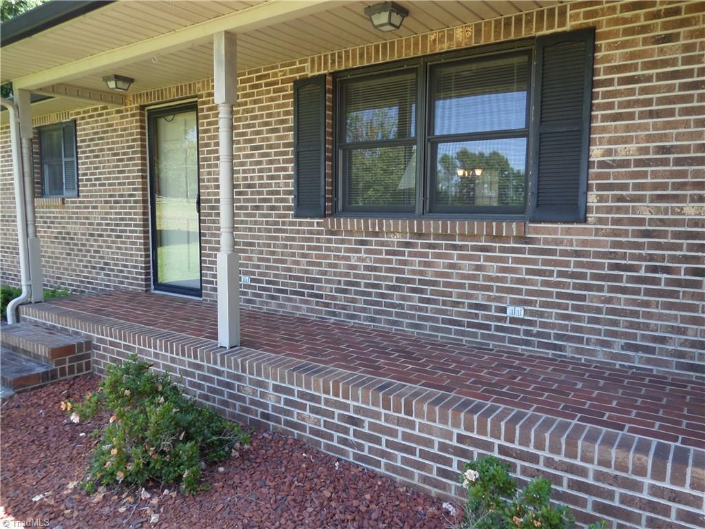 3308 Doub Road East Bend, NC 27018 - Photo 3 of 27 Masonry front porch and vinyl eaves. Sit and relax on this rocking chair front porch.