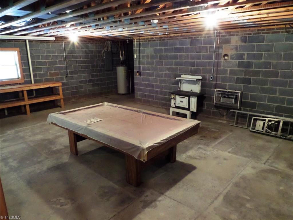 3308 Doub Road East Bend, NC 27018 - Photo 23 of 27 This basement is ready to finish! There is a propane gas heater on the far wall and the pool table stays!