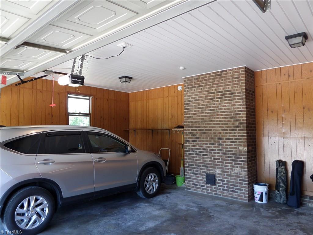 3308 Doub Road East Bend, NC 27018 - Photo 27 of 27 Inside of the garage shows the low maintenance paneling and the recently added vinyl ceiling. Sorry, the car does not remain.