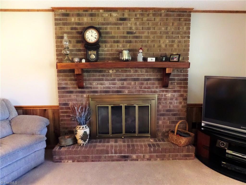 3308 Doub Road East Bend, NC 27018 - Photo 9 of 27 Attractive brick fireplace with a wide mantle and brick hearth.