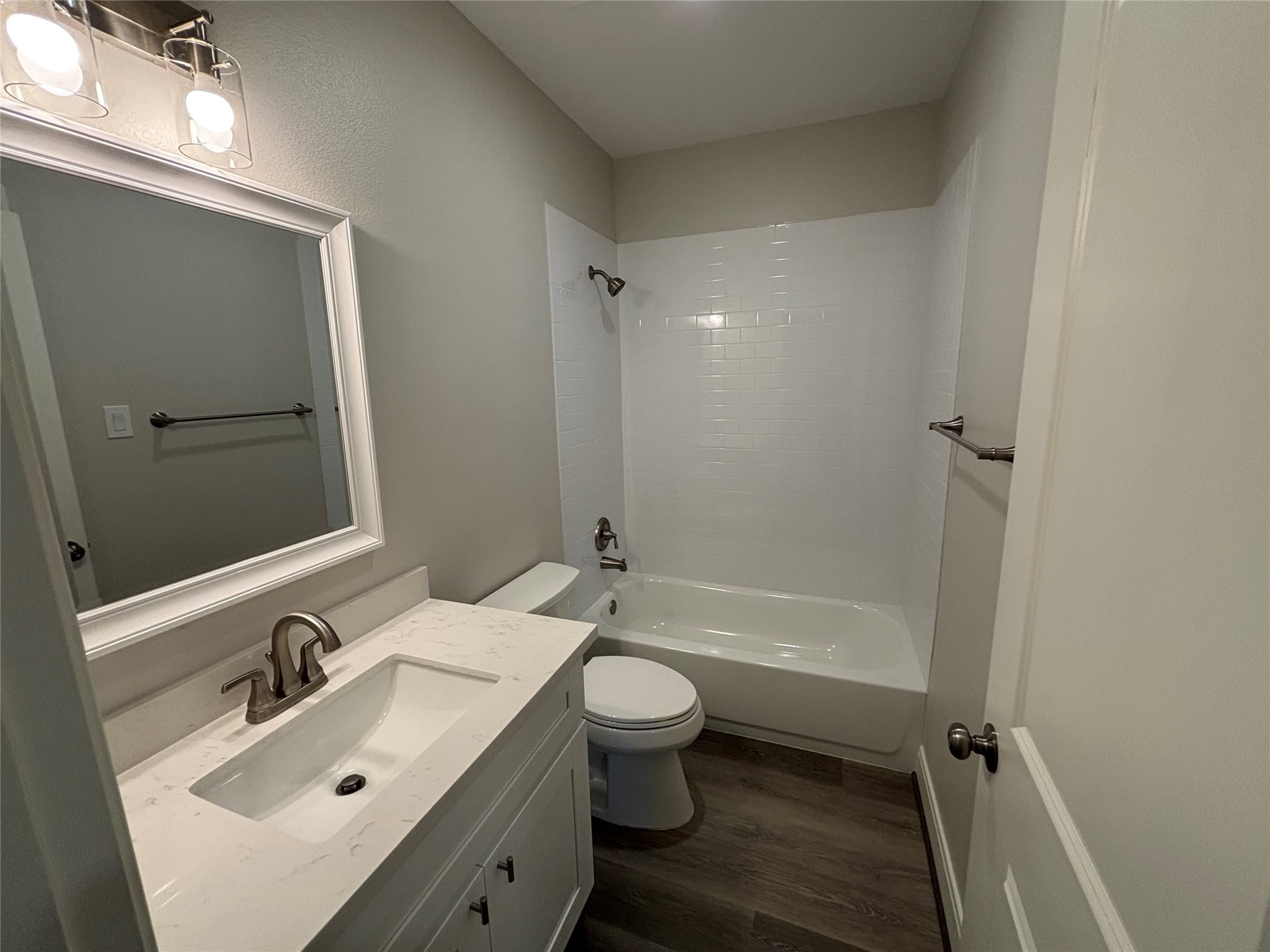 504 Nursery Road, Unit 1209 The Woodlands, TX 77380 - Photo 20 of 27 a bathroom with a sink mirror toilet and bathtub