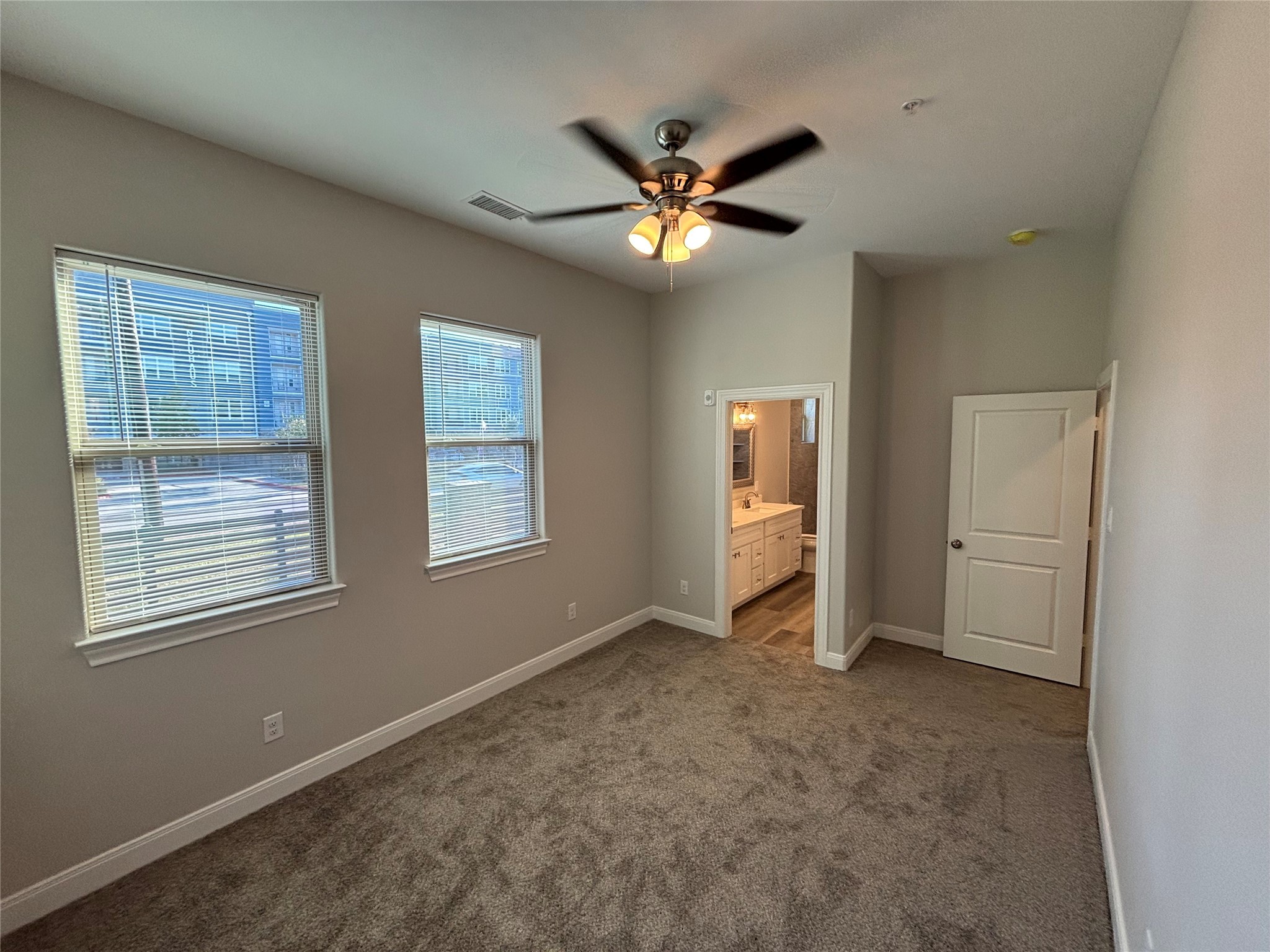 504 Nursery Road, Unit 1209 The Woodlands, TX 77380 - Photo 25 of 27 a view of an empty room with chandelier fan and fire place