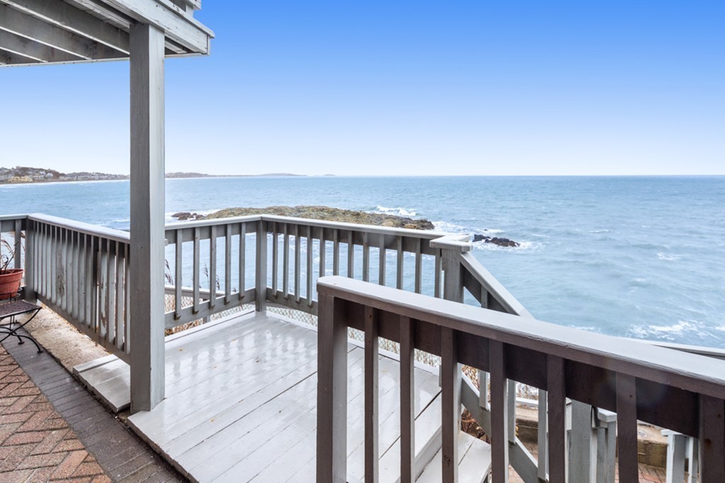 13 Oceanside Drive, Unit 13 Hull, MA 02045 - Photo 2 of 27 a view of a balcony with wooden floor and fence