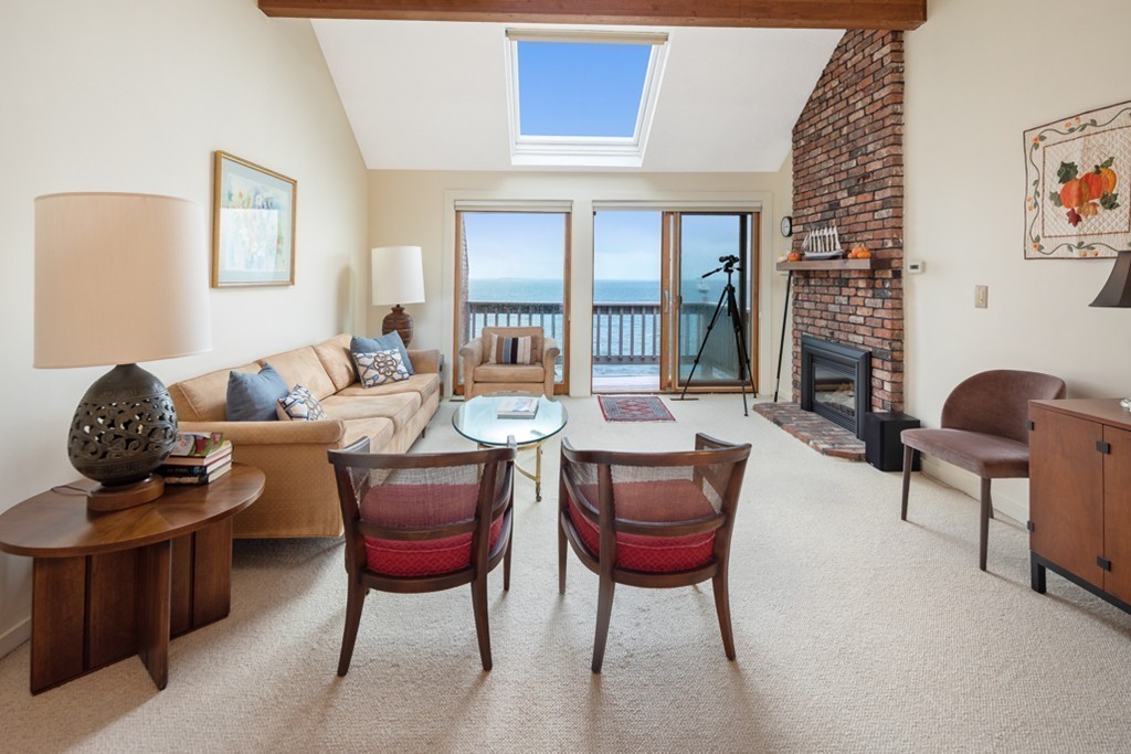 13 Oceanside Drive, Unit 13 Hull, MA 02045 - Photo 4 of 27 a work room with furniture and a potted plant