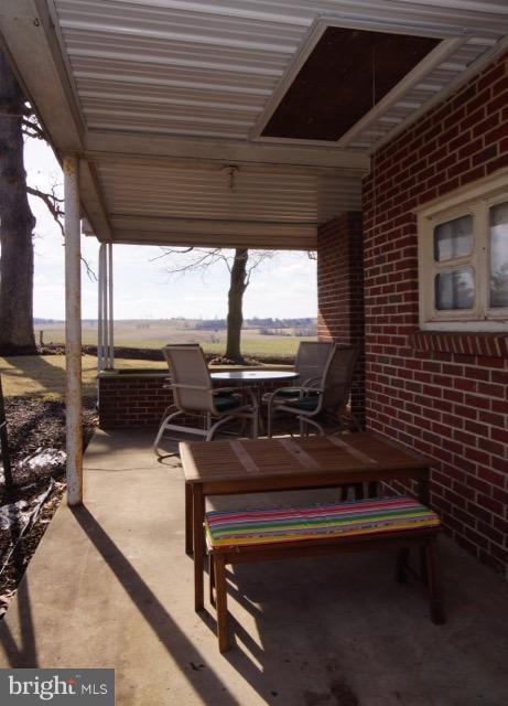 11019 Keymar Road Woodsboro, MD 21798 - Photo 23 of 30 a view of a patio with a table chairs and a barbeque