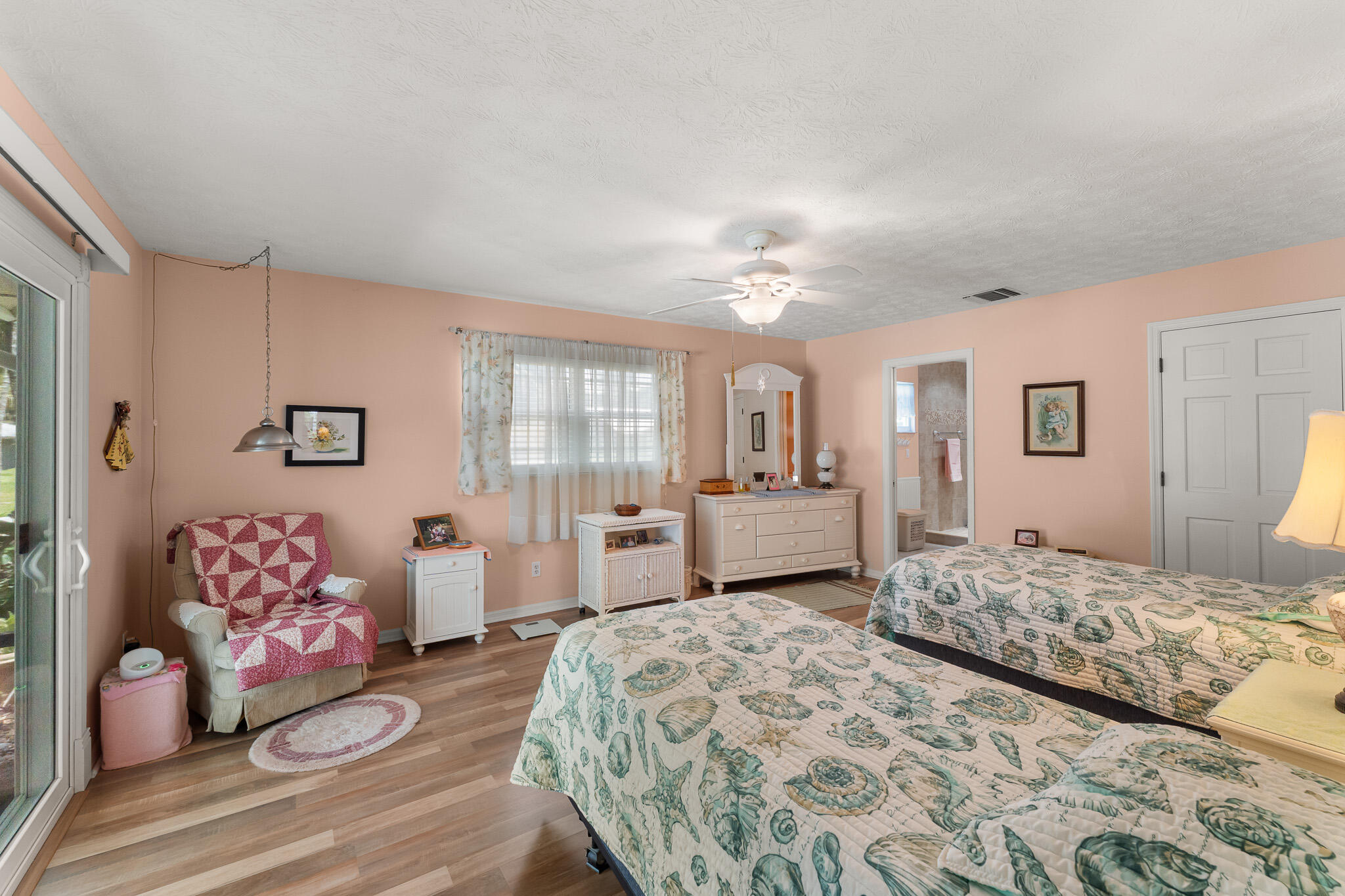 1653 Southwest 85th Terrace Stuart, FL 34997 - Photo 28 of 54 a bedroom with a bed and a chandelier