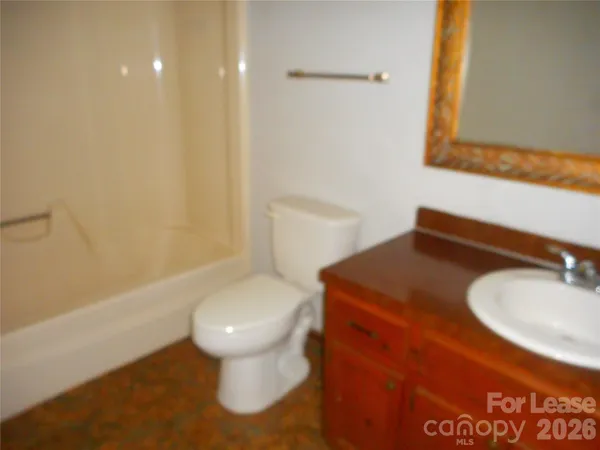 a bathroom with a sink toilet and a mirror