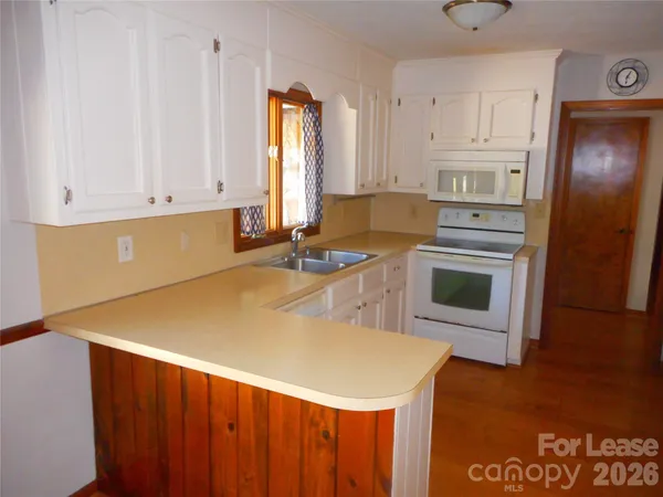 a kitchen with a sink a stove and a microwave