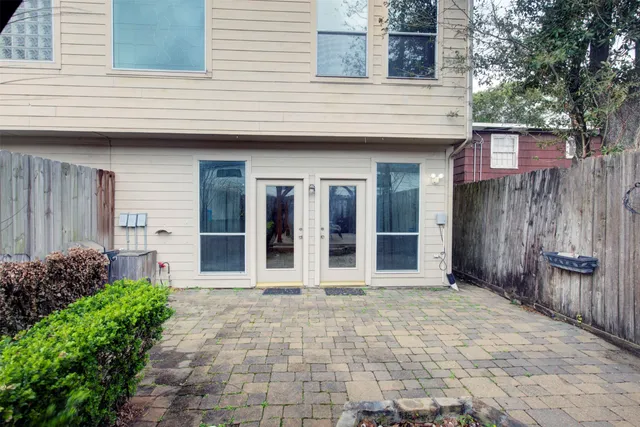 a bedroom with a large bed and a large window
