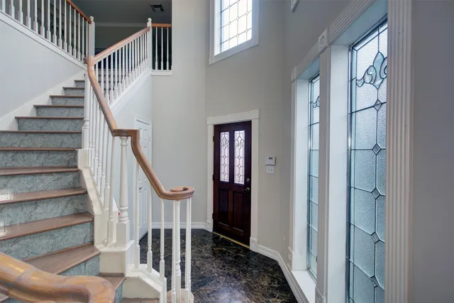 a bathroom with a granite countertop tub sink and mirror