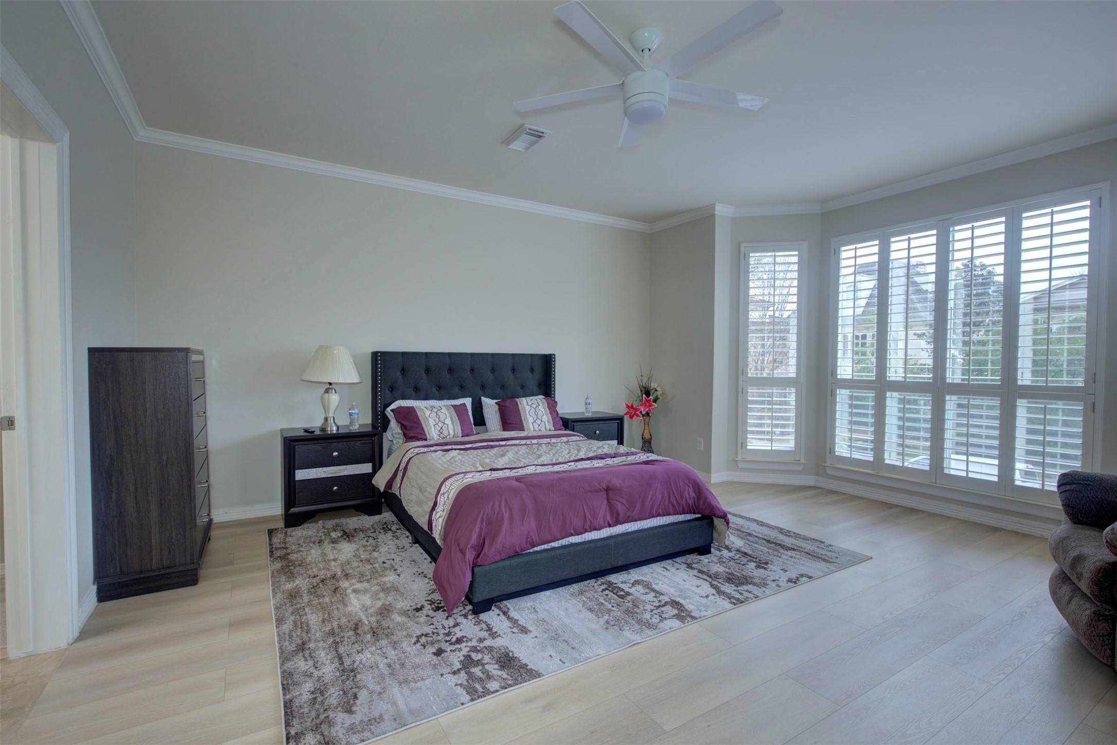 1711 Huldy Street, Unit A Houston, TX 77019 - Photo 13 of 38 a bedroom with a large bed and a large window