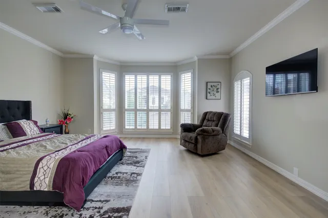 a bedroom with a bed and lamp with window