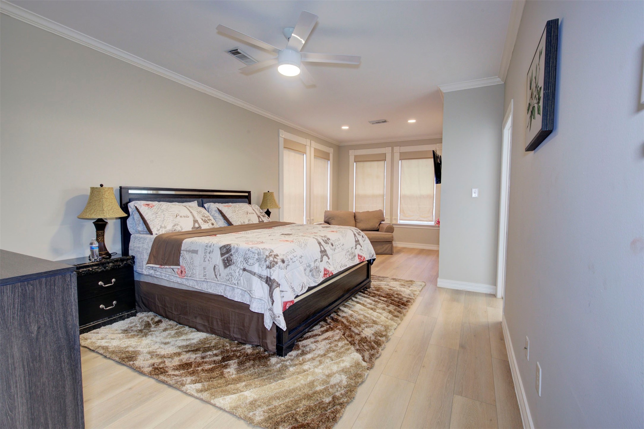 1711 Huldy Street, Unit A Houston, TX 77019 - Photo 18 of 38 a bedroom with a large bed and a chandelier