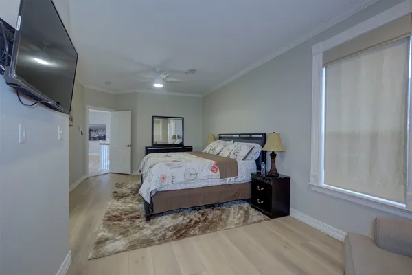 a bedroom with a bed and lamp with window