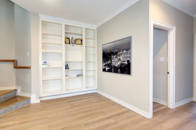 a bedroom with a bed and a window with chair