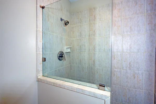 a bathroom with a shower and a sink