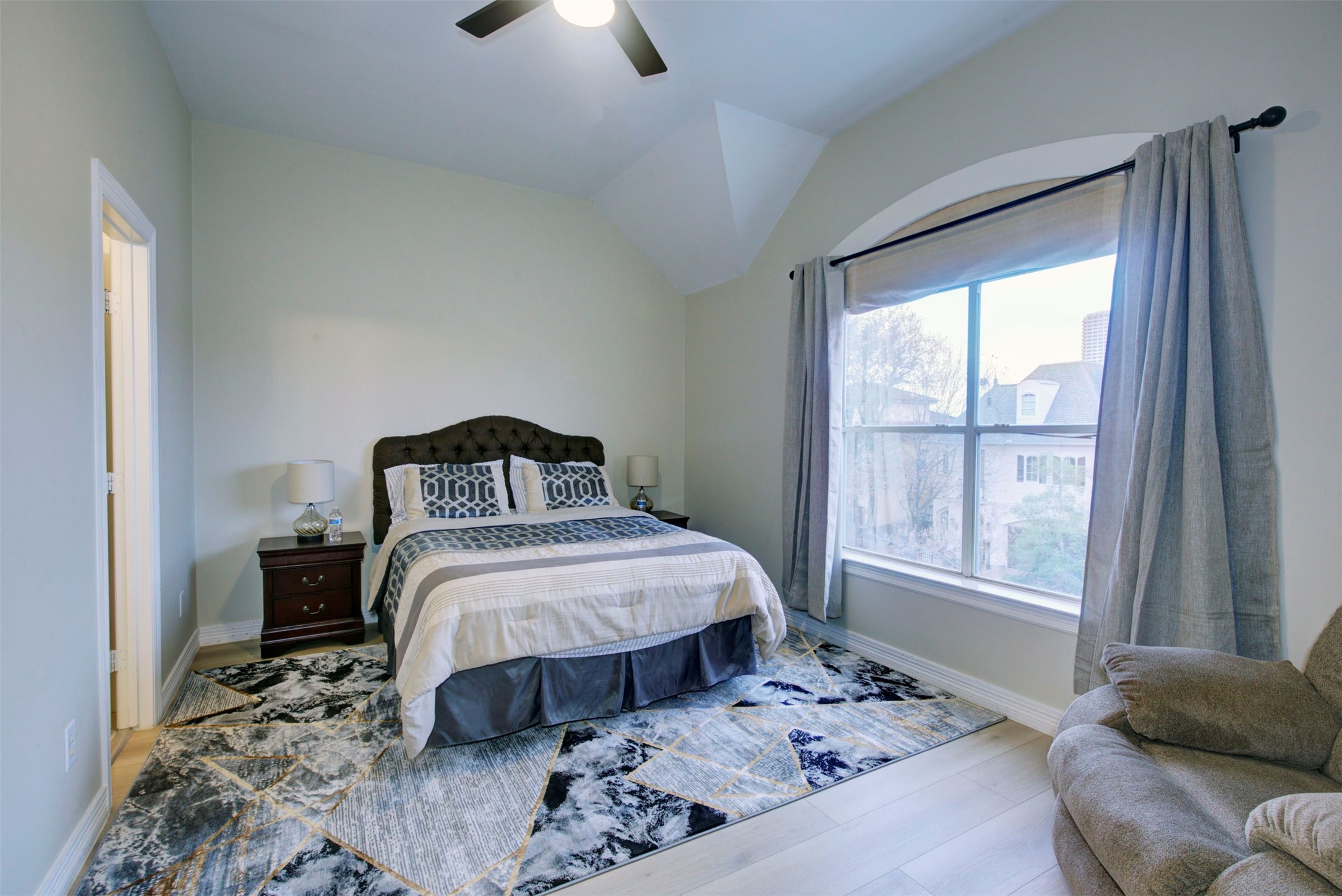 1711 Huldy Street, Unit A Houston, TX 77019 - Photo 30 of 38 a bedroom with a bed and a window with chair
