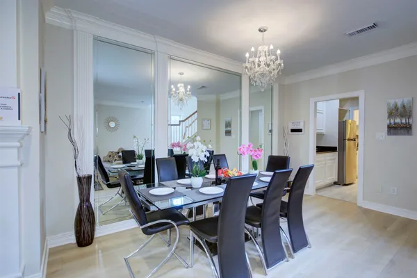 a view of a dining room with furniture and chandelier