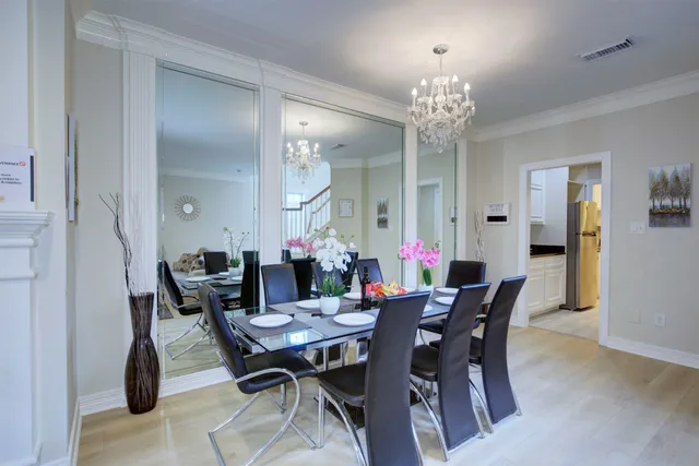 a view of a dining room with furniture and chandelier