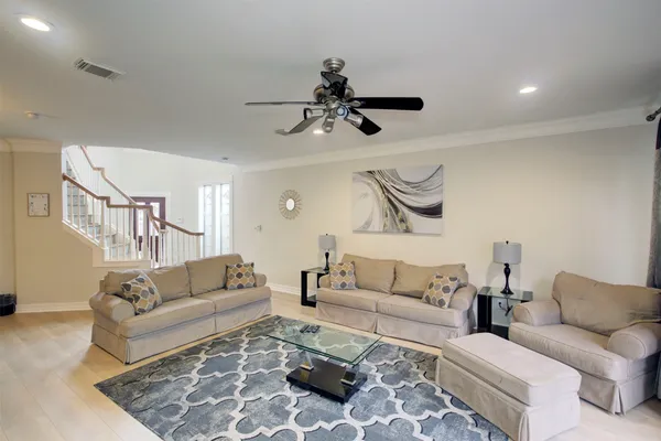 a living room with furniture and a chandelier