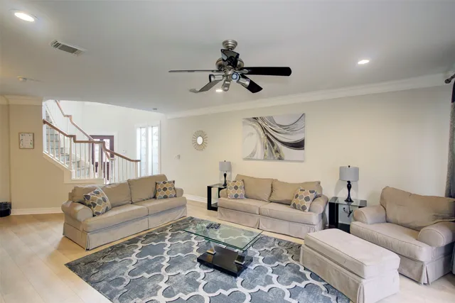 a living room with furniture and a chandelier