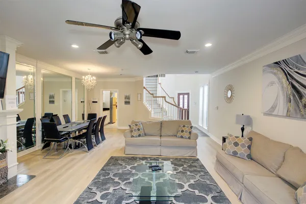 a living room with furniture and wooden floor