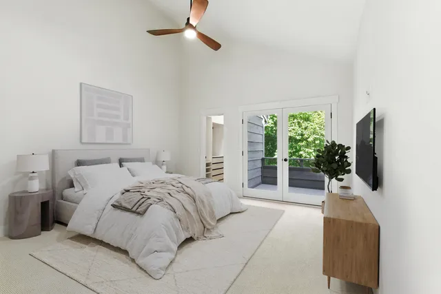 a bedroom with a balcony a bed and a flat screen tv