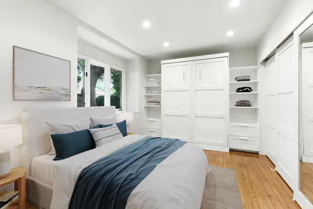 a bedroom with a large bed and a window