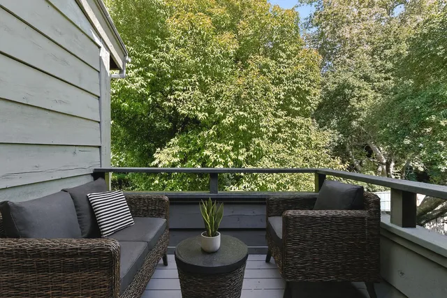 a view of balcony with couches and potted plants