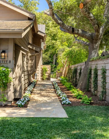 a view of a pathway of house with a yard
