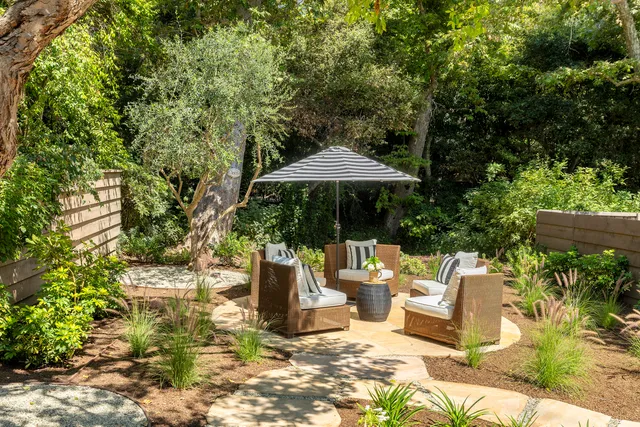 a view of backyard of house with seating space